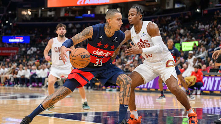 Oct 26, 2024; Washington, District of Columbia, USA; Washington Wizards forward Kyle Kuzma (33) dribbles the ball against Cleveland Cavaliers forward Isaac Okoro (35) during the second quarter at Capital One Arena.