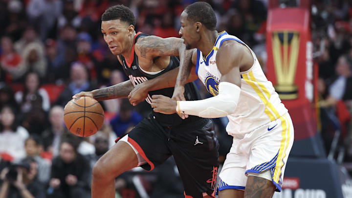 Dec 11, 2024; Houston, Texas, USA; Houston Rockets forward Jabari Smith Jr. (10) drives with the ball as Golden State Warriors forward Jonathan Kuminga (00) defends during the third quarter at Toyota Center. Mandatory Credit: Troy Taormina-Imagn Images