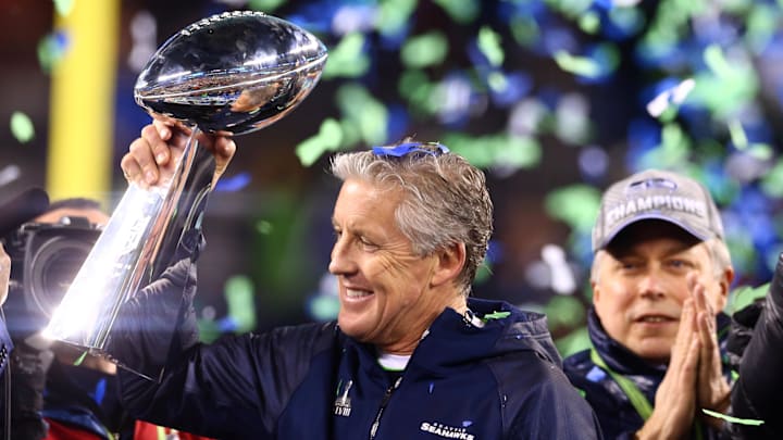 Feb 2, 2014; East Rutherford, NJ, USA; Seattle Seahawks head coach Pete Carroll hoists the Vince Lombardi Trophy after Super Bowl XLVIII against the Denver Broncos at MetLife Stadium.  Mandatory Credit: Mark J. Rebilas-Imagn Images