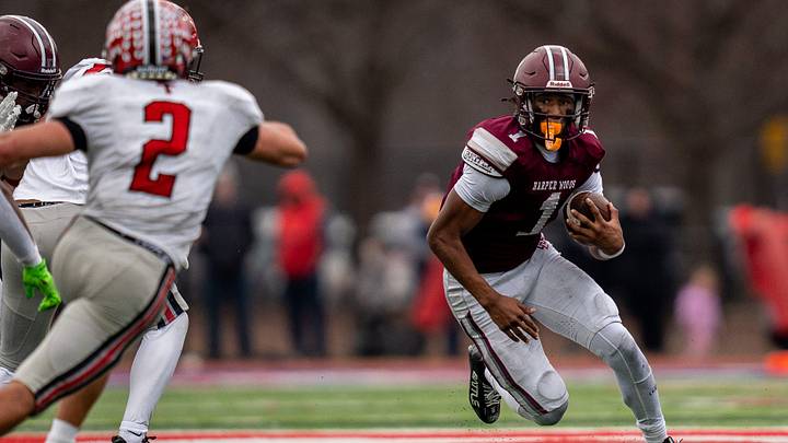 Harper Woods wide receiver Dakota Guerrant runs the ball against the Dearborn Divine Child defense during a Division 4 regional final at John Glenn High School in Westland on Saturday, Nov. 15, 2025.