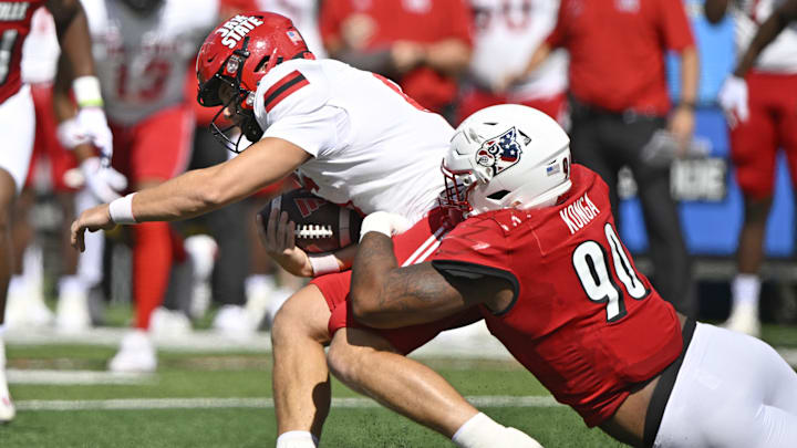 Sep 7, 2024; Louisville, Kentucky, USA;  Louisville Cardinals defensive lineman Rene Konga (90) sacks Jacksonville State Gamecocks quarterback Tyler Huff (6) during the first quarter at L&N Federal Credit Union Stadium. Mandatory Credit: Jamie Rhodes-Imagn Images