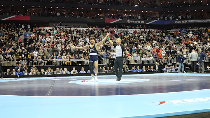 Penn State wrestler Carter Starocci celebrates after winning his fourth NCAA Wrestling title. 