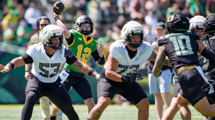 Behind good protection, Brock Thomas throws a pass in the Oregon Spring Game for the Fighting Ducks. O-line coach A'lique Terry has to identify three new starters for the Ducks to achieve high expectations this season.