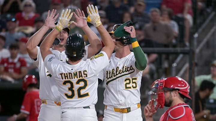 Aug 15, 2025; West Sacramento, California, USA; Athletics outfielder Colby Thomas (32) celebrates with first baseman Nick Kurtz (16) and outfielder Brent Rooker (25) after hitting a home run against the Los Angeles Angels during the third inning at Sutter Health Park. Mandatory Credit: Ed Szczepanski-Imagn Images