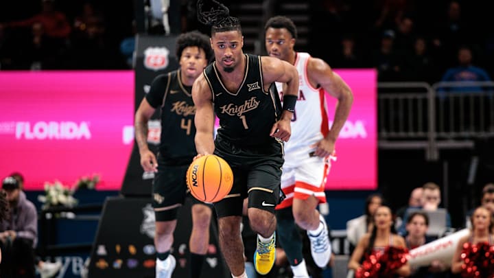 Mar 12, 2026; Kansas City, MO, USA; UCF Knights guard Themus Fulks (1) brings the ball up court during the second half against the Arizona Wildcats at T-Mobile Center. Mandatory Credit: William Purnell-Imagn Images Mar 12, 2026; Kansas City, MO, USA; UCF Knights guard Themus Fulks (1) brings the ball up court during the second half against the Arizona Wildcats at T-Mobile Center. Mandatory Credit: William Purnell-Imagn Images