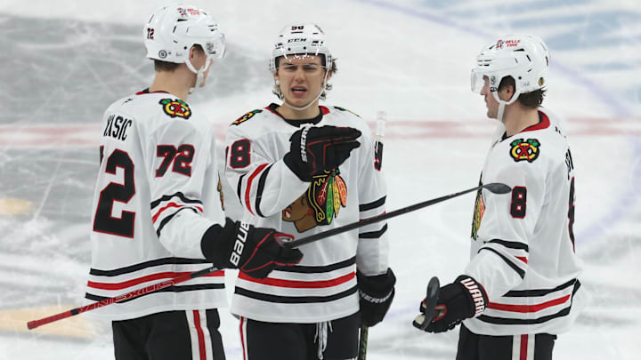 Apr 8, 2025; Pittsburgh, Pennsylvania, USA;  Chicago Blackhawks defenseman Alex Vlasic (72) and center Connor Bedard (98) and center Ryan Donato (8) talk on the ice against the Pittsburgh Penguins during the second period at PPG Paints Arena. Mandatory Credit: Charles LeClaire-Imagn Images