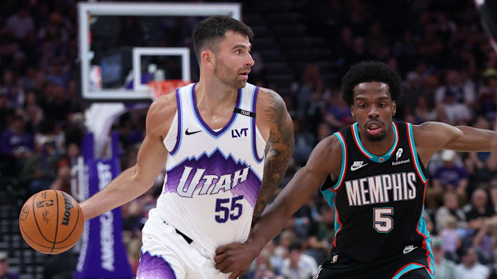 Apr 10, 2026; Salt Lake City, Utah, USA; Utah Jazz guard John Konchar (55) dribbles with the ball against Memphis Grizzlies forward Toby Okani (5) during the second half at Delta Center. Mandatory Credit: Rob Gray-Imagn Images