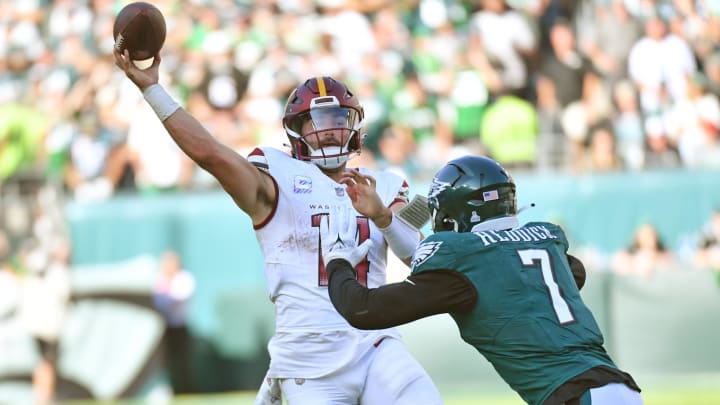 Oct 1, 2023; Philadelphia, Pennsylvania, USA; Washington Commanders quarterback Sam Howell (14) throws a pass under pressure from Philadelphia Eagles linebacker Haason Reddick (7) during the fourth quarter at Lincoln Financial Field. 