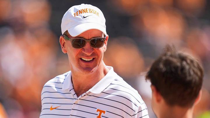 Peyton Manning smiles at a fan on the sidelines before a NCAA football game between Tennessee and Georgia at Neyland Stadium in Knoxville, Tennessee, on September 13, 2025.