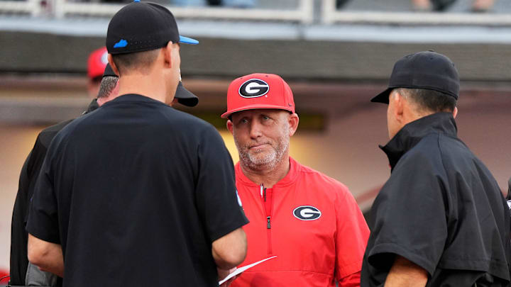 Georgia coach Wes Johnson meets with Kentucky coach Nick Mingione before the start of a NCAA baseball game on March 14, 2025.