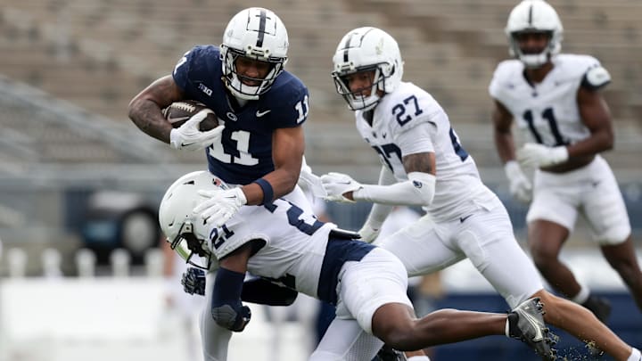 Penn State Nittany Lions wide receiver Kyron Hudson (11) runs with the ball as safety Vaboue Toure (21) pursues during the Blue-White spring game at Beaver Stadium. Penn State Nittany Lions wide receiver Kyron Hudson (11) runs with the ball as safety Vaboue Toure (21) pursues during the Blue-White spring game at Beaver Stadium.
