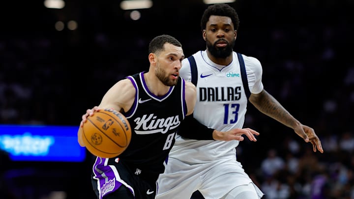 Apr 16, 2025; Sacramento, California, USA; Sacramento Kings guard Zach LaVine (8) dribbles the ball against Dallas Mavericks forward Naji Marshall (13) during the fourth quarter at Golden 1 Center. Mandatory Credit: Sergio Estrada-Imagn Images