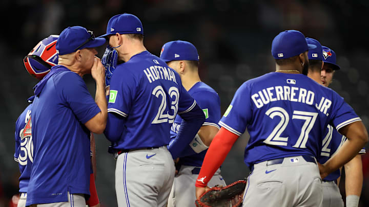 May 7, 2025; Anaheim, California, USA; Toronto Blue Jays relief pitcher Jeff Hoffman (23) talks to pitching coach Pete Walker during the ninth inning against the Los Angeles Angels at Angel Stadium.