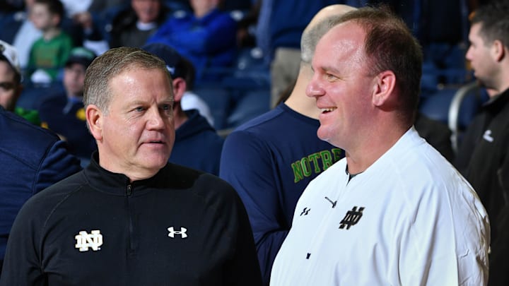 Feb 7, 2017; South Bend, IN, USA; Notre Dame Fighting Irish head football coach Brian Kelly and his defensive coordinator Mike Elko watch warmups before the game between the Notre Dame Fighting Irish and the Wake Forest Demon Deacons at the Purcell Pavilion. Mandatory Credit: Matt Cashore-Imagn Images