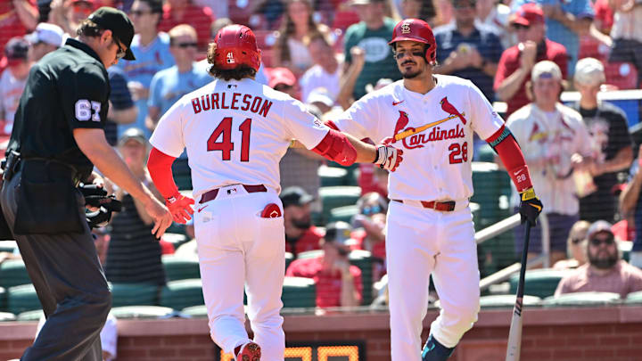 Sep 17, 2025; St. Louis, Missouri, USA; St. Louis Cardinals first baseman Alec Burleson (41) is congratulated at home plate by St. Louis Cardinals third baseman Nolan Arenado (28) after he hit a home run against the Cincinnati Reds in the first inning at Busch Stadium. Mandatory Credit: Tim Vizer-Imagn Images