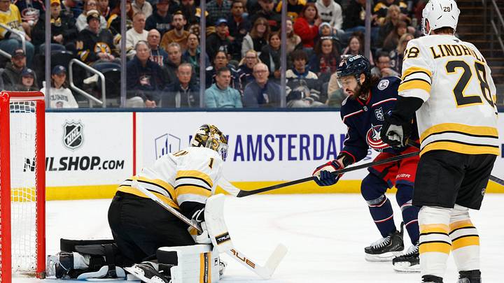 Mar 29, 2026; Columbus, Ohio, USA; Boston Bruins goalie Jeremy Swayman (1) makes a save as Columbus Blue Jackets right wing Kirill Marchenko (86) looks for a rebound during the second period at Nationwide Arena. Mandatory Credit: Russell LaBounty-Imagn Images