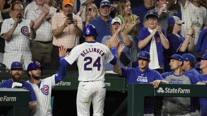 Jun 18, 2024; Chicago, Illinois, USA; Chicago Cubs outfielder Cody Bellinger (24) is greeted after scoring against the San Francisco Giants during the eighth inning at Wrigley Field.