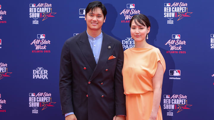 National League designated hitter Shohei Ohtani (17) of the Los Angeles Dodgers and wife Mamiko Tanaka pose for a photo on the red carpet before the 2025 MLB All Star Game at Truist Park.
