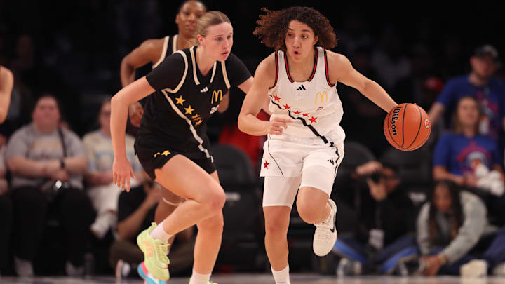 Apr 1, 2025; Brooklyn, NY, USA; McDonald's All American West guard Aaliyah Chavez (2) dribbles the ball against McDonald's All American East wing Kaelyn Carroll (20) during the first half of the game at Barclays Center. Mandatory Credit: Pamela Smith-Imagn Images
