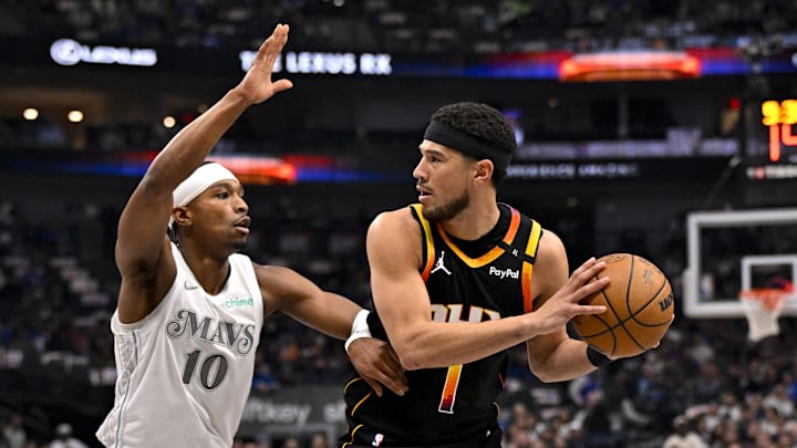 Dallas Mavericks guard Brandon Williams (10) and Phoenix Suns guard Devin Booker (1) in action during the game between the Dallas Mavericks and the Phoenix Suns at American Airlines Center. Mandatory Credit: Jerome Miron-Imagn Images