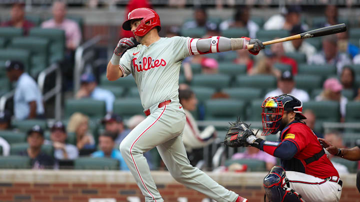 Jul 5, 2024; Atlanta, Georgia, USA; Philadelphia Phillies second baseman Whit Merrifield (9) hits a single against the Atlanta Braves in the second inning at Truist Park. Jul 5, 2024; Atlanta, Georgia, USA; Philadelphia Phillies second baseman Whit Merrifield (9) hits a single against the Atlanta Braves in the second inning at Truist Park.