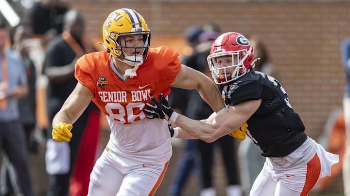 Jan 30, 2025; Mobile, AL, USA; American team tight end Mason Taylor of LSU (86) and American team defensive back Dan Jackson of Georgia (37) spar during Senior Bowl practice for the American team at Hancock Whitney Stadium. Mandatory Credit: Vasha Hunt-Imagn Images