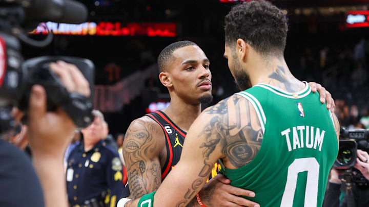 Apr 27, 2023; Atlanta, Georgia, USA; Atlanta Hawks guard Dejounte Murray (5) talks to Boston Celtics forward Jayson Tatum (0) after game six of the 2023 NBA playoffs at State Farm Arena. Mandatory Credit: Brett Davis-Imagn Images