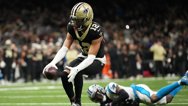 Dec 14, 2025; New Orleans, Louisiana, USA; New Orleans Saints wide receiver Chris Olave (12) scores a touchdown in the fourth quarter against the Carolina Panthers at Caesars Superdome. Mandatory Credit: Matthew Hinton-Imagn Images Dec 14, 2025; New Orleans, Louisiana, USA; New Orleans Saints wide receiver Chris Olave (12) scores a touchdown in the fourth quarter against the Carolina Panthers at Caesars Superdome. Mandatory Credit: Matthew Hinton-Imagn Images
