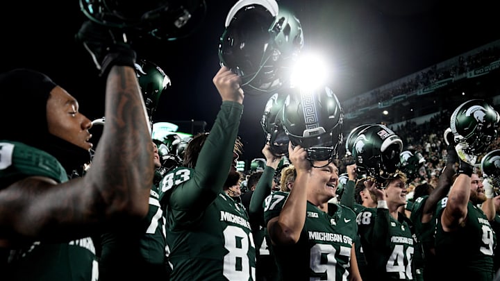 Oct 19, 2024; East Lansing, Michigan, USA;  Michigan State Spartans place kicker Jonathan Kim (97) sings with his team as he celebrates kicking six field goals against the Iowa Hawkeyes at Spartan Stadium. Mandatory Credit: Dale Young-Imagn Images