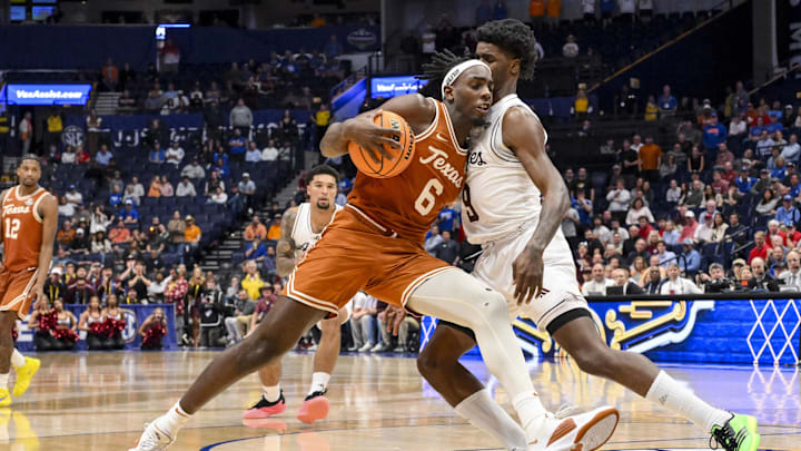 Mar 13, 2025; Nashville, TN, USA;  Texas Longhorns forward Arthur Kaluma (6) dribbles past Texas A&M Aggies forward Solomon Washington (9) during the second half at Bridgestone Arena. Mandatory Credit: Steve Roberts-Imagn Images