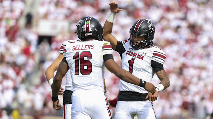 Oct 19, 2024; Norman, Oklahoma, USA; South Carolina Gamecocks quarterback LaNorris Sellers (16) celebrates with South Carolina Gamecocks quarterback Robby Ashford (1) after a touchdown against the Oklahoma Sooners during the first half at Gaylord Family-Oklahoma Memorial Stadium. Mandatory Credit: Kevin Jairaj-Imagn Images Oct 19, 2024; Norman, Oklahoma, USA; South Carolina Gamecocks quarterback LaNorris Sellers (16) celebrates with South Carolina Gamecocks quarterback Robby Ashford (1) after a touchdown against the Oklahoma Sooners during the first half at Gaylord Family-Oklahoma Memorial Stadium. Mandatory Credit: Kevin Jairaj-Imagn Images