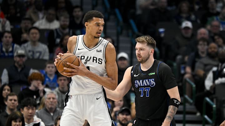 Feb 14, 2024; Dallas, Texas, USA; San Antonio Spurs center Victor Wembanyama (1) looks to move the ball past Dallas Mavericks guard Luka Doncic (77) during the fist quarter at the American Airlines Center. Mandatory Credit: Jerome Miron-Imagn Images