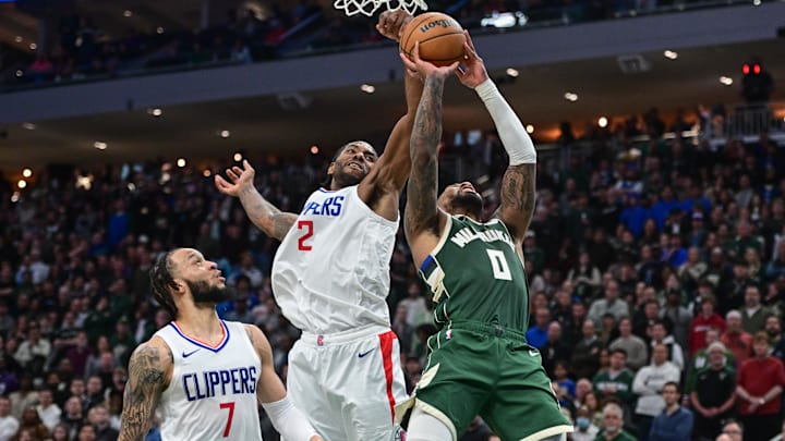 Mar 4, 2024; Milwaukee, Wisconsin, USA; Milwaukee Bucks guard Damian Lillard (0) takes a shot against Los Angeles Clippers forward Kawhi Leonard (2) and forward Amir Coffey (7) in the fourth quarter at Fiserv Forum. Mandatory Credit: Benny Sieu-Imagn Images