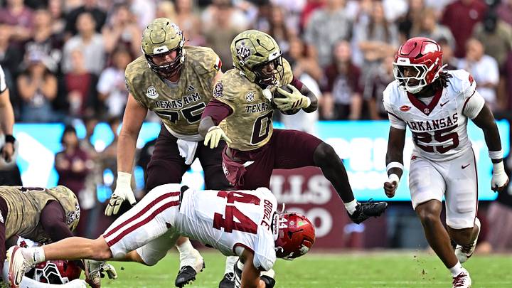 Oct 3, 2026; College Station, Texas, USA; Texas A&M Aggies running back KJ Edwards (0) runs the ball as Arkansas Razorbacks linebacker Ben Bogle (44) attempts a tackle during the first half at Kyle Field. Mandatory Credit: Maria Lysaker-Imagn Images Oct 3, 2026; College Station, Texas, USA; Texas A&M Aggies running back KJ Edwards (0) runs the ball as Arkansas Razorbacks linebacker Ben Bogle (44) attempts a tackle during the first half at Kyle Field. Mandatory Credit: Maria Lysaker-Imagn Images