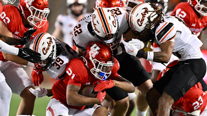 Nov 18, 2023; Houston, Texas, USA; Houston Cougars running back Stacy Sneed (21) is tackled on the return during the fourth quarter against the Houston Cougars at TDECU Stadium. Mandatory Credit: Maria Lysaker-Imagn Images Nov 18, 2023; Houston, Texas, USA; Houston Cougars running back Stacy Sneed (21) is tackled on the return during the fourth quarter against the Houston Cougars at TDECU Stadium. Mandatory Credit: Maria Lysaker-Imagn Images