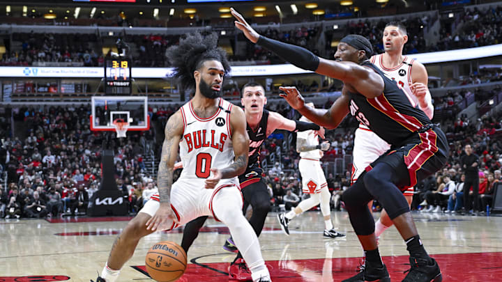 Feb 4, 2025; Chicago, Illinois, USA;  Chicago Bulls guard Coby White (0) moves the ball past Miami Heat center Bam Adebayo (13) during the first half at United Center. Mandatory Credit: Matt Marton-Imagn Images