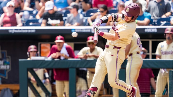 Jun 18, 2024; Omaha, NE, USA; Florida State Seminoles right fielder James Tibbs III (22) hits a double against the North Carolina Tar Heels during the fifth inning at Charles Schwab Field Omaha. 