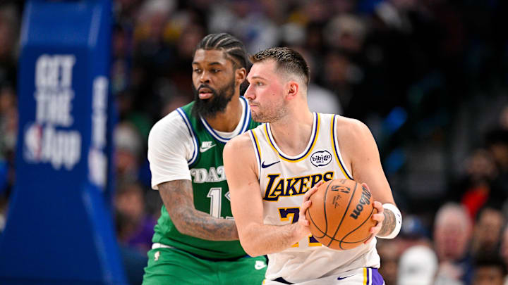 Jan 24, 2026; Dallas, Texas, USA; Los Angeles Lakers guard Luka Doncic (77) controls the ball in front of Dallas Mavericks forward Naji Marshall (13) during the game at the American Airlines Center. Mandatory Credit: Jerome Miron-Imagn Images