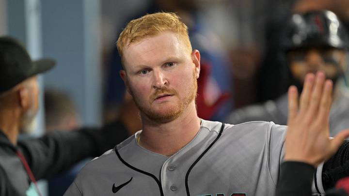 Mar 27, 2026; Los Angeles, California, USA; Arizona Diamondbacks first baseman Pavin Smith (26) celebrates in the dugout after scoring on an RBI double by center fielder Alek Thomas (not pictured) in the fourth inning against the Los Angeles Dodgers at Dodger Stadium. Mandatory Credit: Jayne Kamin-Oncea-Imagn Images