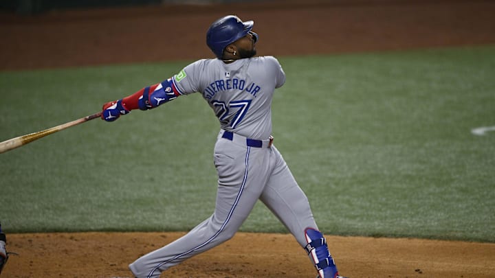 Sep 17, 2024; Arlington, Texas, USA; Toronto Blue Jays first baseman Vladimir Guerrero Jr. (27) hits a double and drives in a run against the Texas Rangers during the second inning at Globe Life Field. Sep 17, 2024; Arlington, Texas, USA; Toronto Blue Jays first baseman Vladimir Guerrero Jr. (27) hits a double and drives in a run against the Texas Rangers during the second inning at Globe Life Field.