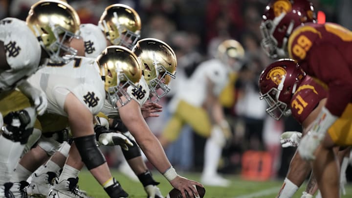 Nov 26, 2022; Los Angeles, California, USA; A general overall view of helmets at the line of scrimmage as Notre Dame Fighting Irish offensive lineman Zeke Correll (52) snaps the ball against the Southern California Trojans in the second half at United Airlines Field at Los Angeles Memorial Coliseum. 