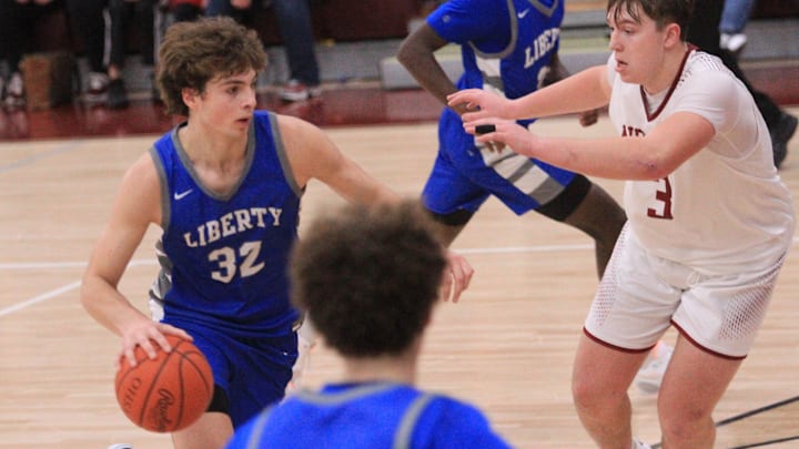Olentangy Liberty's Tyler Kropp drives from the top of the key against Newark's Steele Meister during the visiting Patriots' 58-49 victory at Jimmy Allen Gymnasium on Tuesday, Dec. 19, 2023.