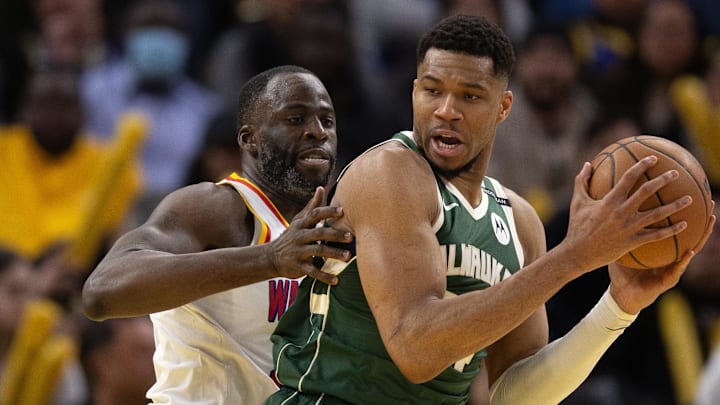 Mar 18, 2025; San Francisco, California, USA; Milwaukee Bucks forward Giannis Antetokounmpo (34) attempts to turn and shoot over Golden State Warriors forward Draymond Green (left) during the fourth quarter at Chase Center. Mandatory Credit: D. Ross Cameron-Imagn Images