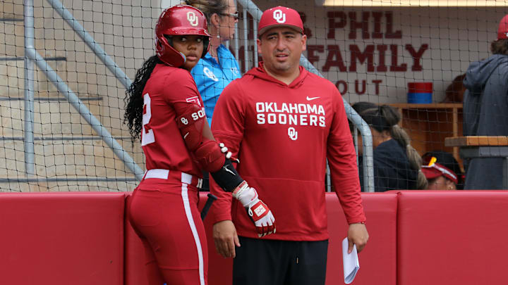 Oklahoma associate head coach and hitting coach JT Gasso talks with Kai Minor before an at-bat against Kentucky.