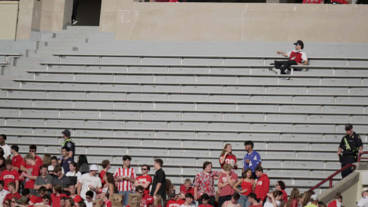 Oct 18, 2025; Madison, Wisconsin, USA; A man has a large seating area to himself during the second quarter of the Wisconsin - Ohio State football game at Camp Randall Stadium.