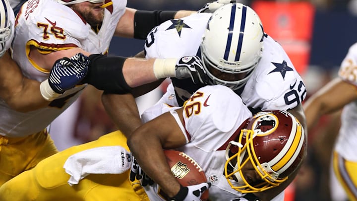Washington Redskins running back Alfred Morris tackled by Dallas Cowboys nose tackle Josh Brent