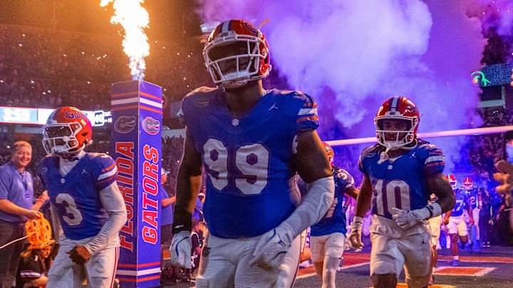 Florida Gators defensive lineman Cam Jackson (99) runs out of the tunnel with the team as fireworks and fire shoot out of towers before the start of the game at Ben Hill Griffin Stadium in Gainesville, FL on Saturday, October 5, 2024. [Doug Engle/Gainesville Sun]