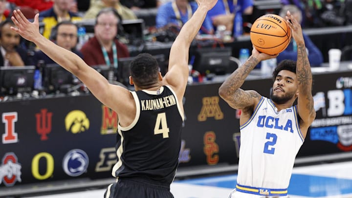 Mar 14, 2026; Chicago, IL, USA; UCLA Bruins guard Donovan Dent (2) shoots against Purdue Boilermakers forward Trey Kaufman-Renn (4) during the first half at United Center. Mandatory Credit: Kamil Krzaczynski-Imagn Images
