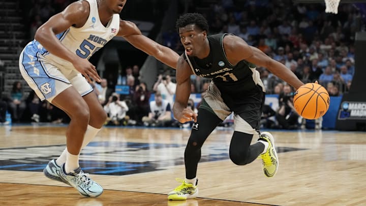 March 21, 2024, Charlotte, NC, USA; Wagner Seahawks guard Melvin Council Jr. (11) drives against North Carolina Tar Heels forward Harrison Ingram (55) in the first round of the 2024 NCAA Tournament at the Spectrum Center. Mandatory Credit: Jim Dedmon-Imagn Images