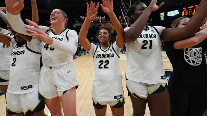 Colorado Buffaloes guard Shelomi Sanders and teammates celebrate defeating the Oregon Ducks.